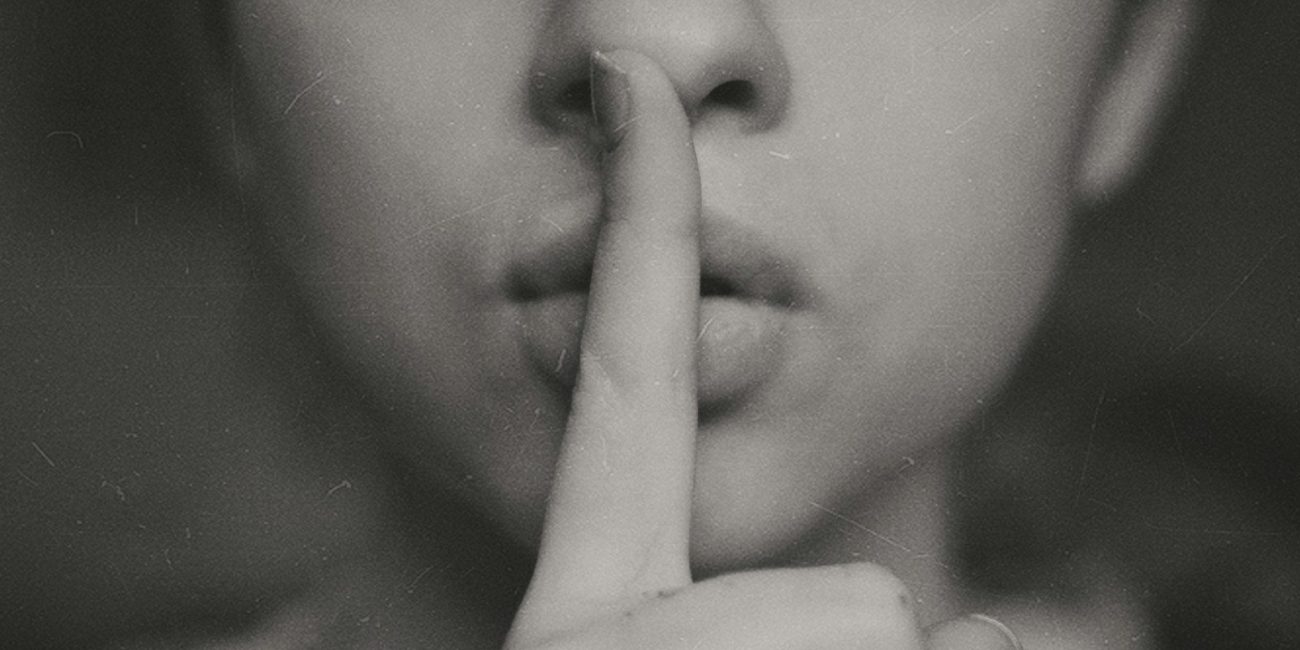 grayscale photo of woman doing silent hand sign