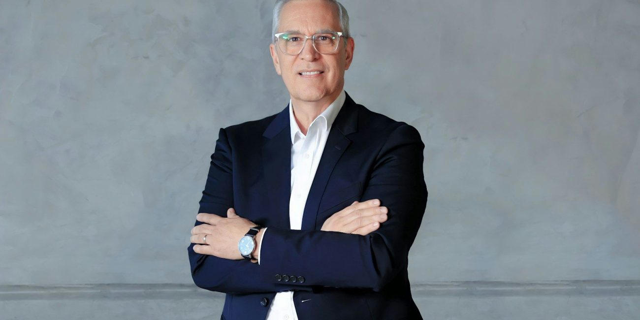 a man in a suit standing with his arms crossed