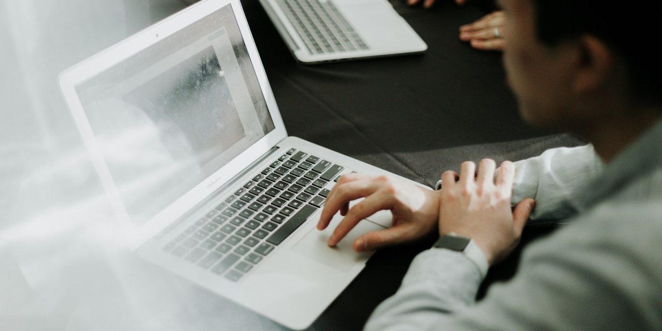 a man sitting in front of a laptop computer