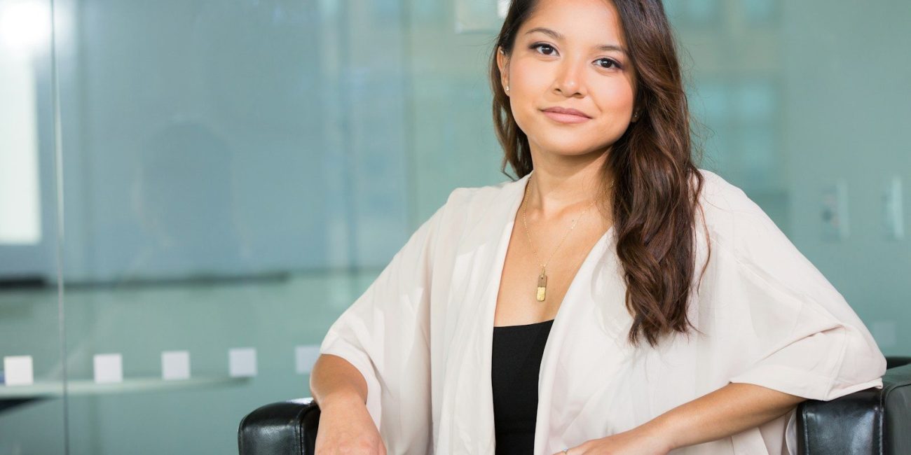 woman smiling and sitting